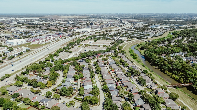 Rapid growing area Lewisville Texas along Highway 12 Sam Rayburn Tollway, mixed-use development of commercial buildings, warehouse logistic center, residential houses, DFW landfill in background. USA